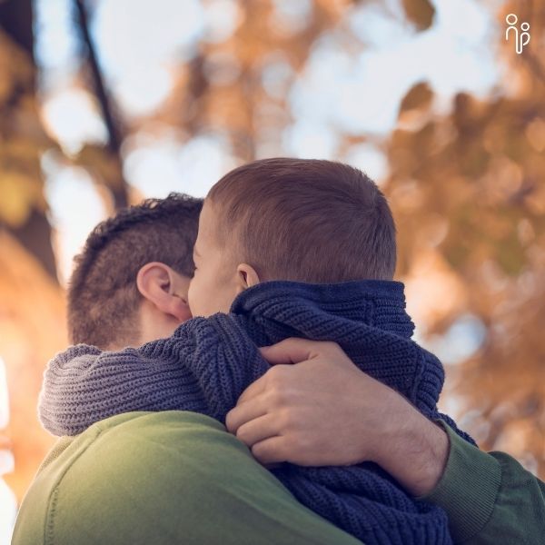 Dad and son hug